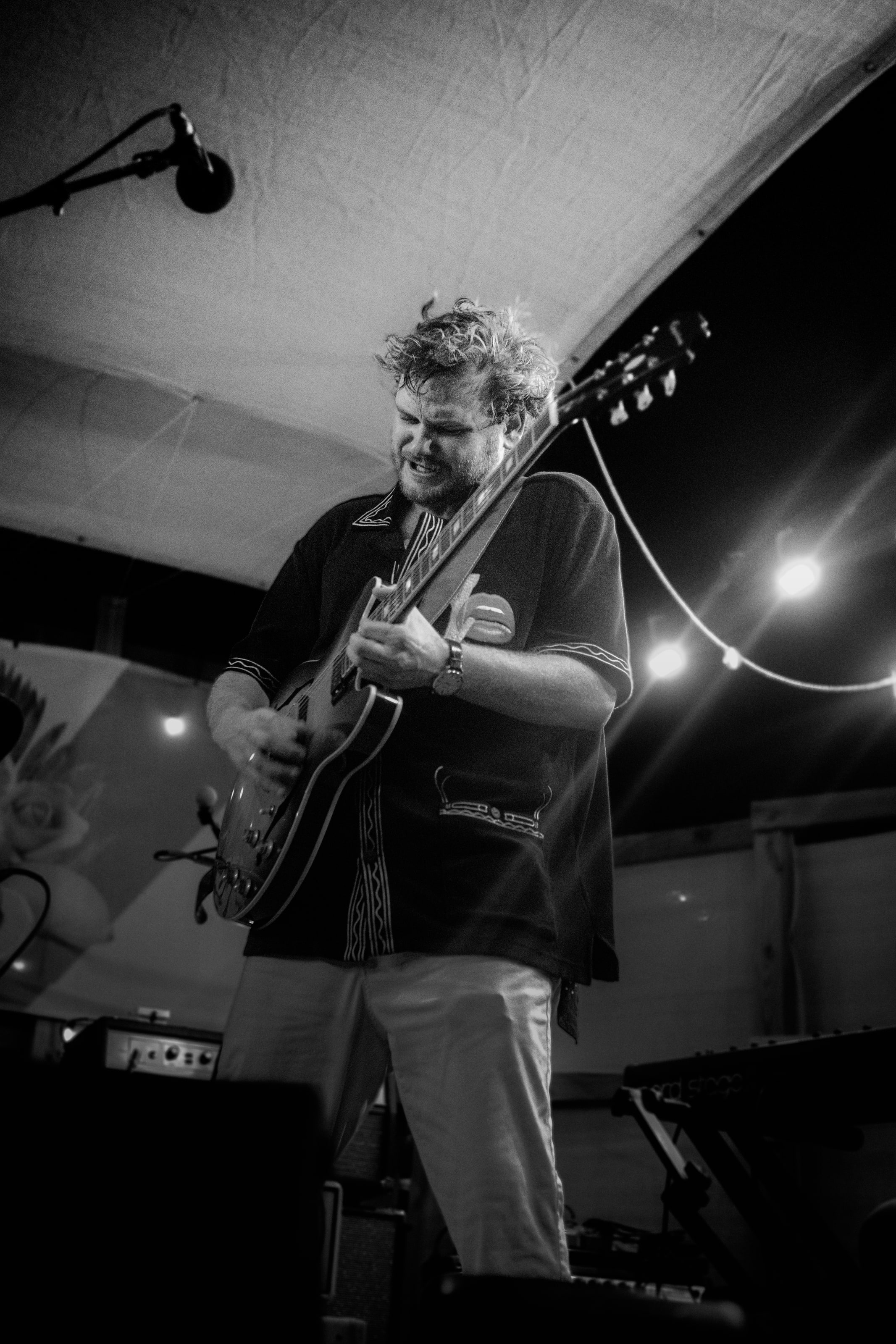 John Elijah playing guitar during a live performance